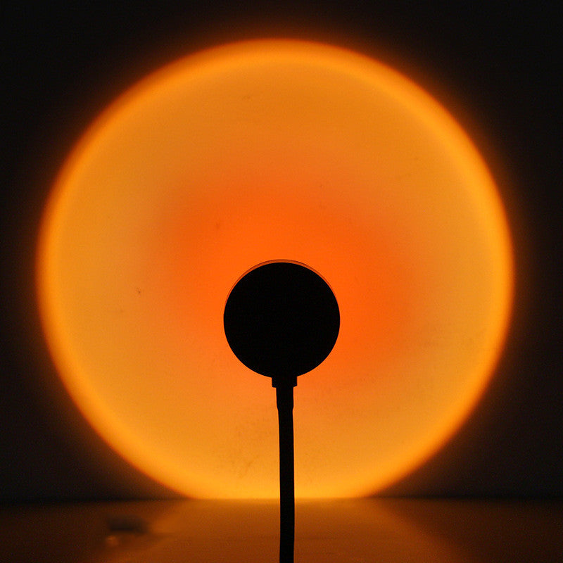 Sunset lamp projecting a warm orange sunset glow
